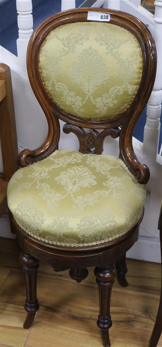 A Victorian carved walnut revolving piano stool